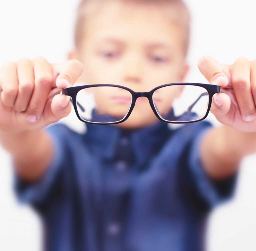 boy holding glasses