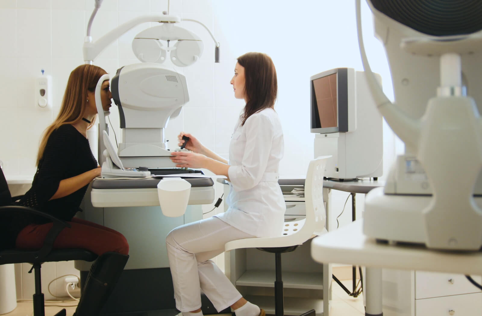 An optometrist carefully examining a patient's eyes for early signs of glaucoma and other eye conditions.