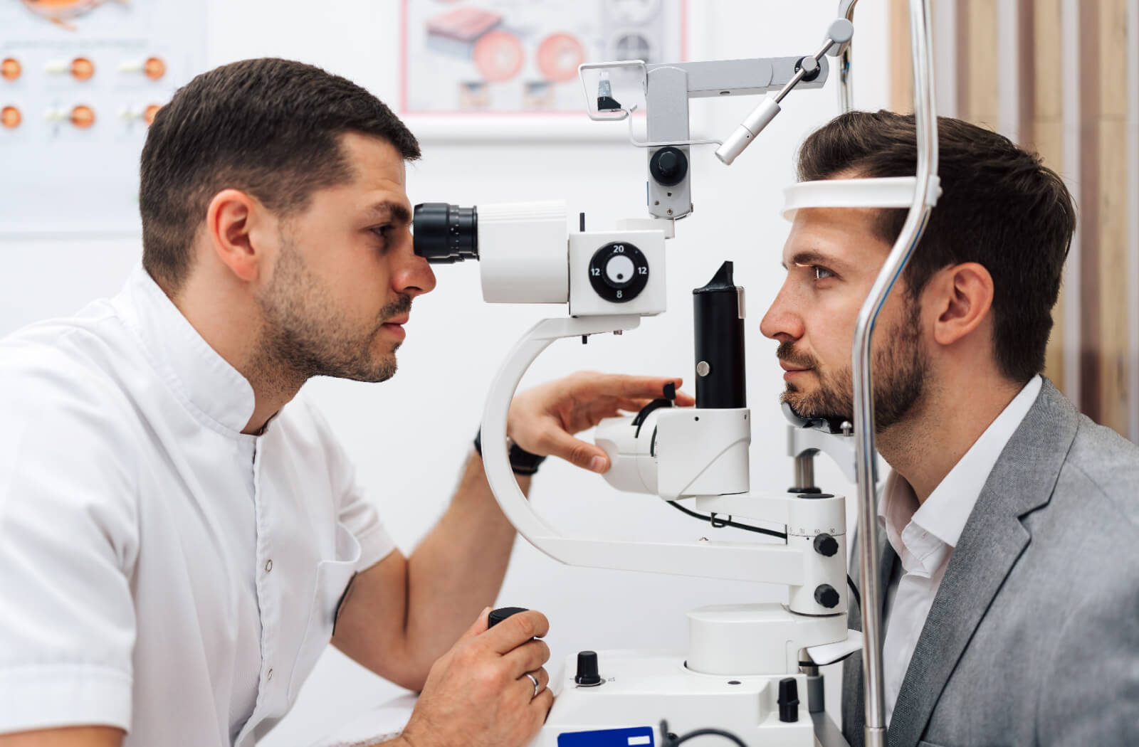 A side view of an optometrist examining a patient's eyes during an eye exam to find out if Neurolens is right for them.