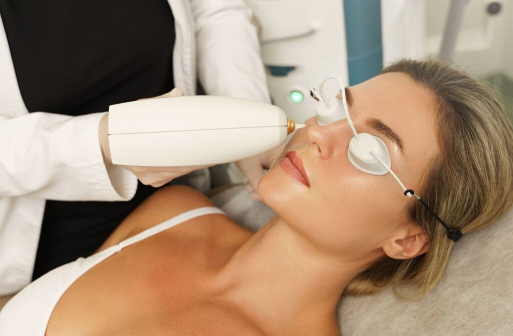 Person receiving IPL facial treatment for skin rejuvenation.