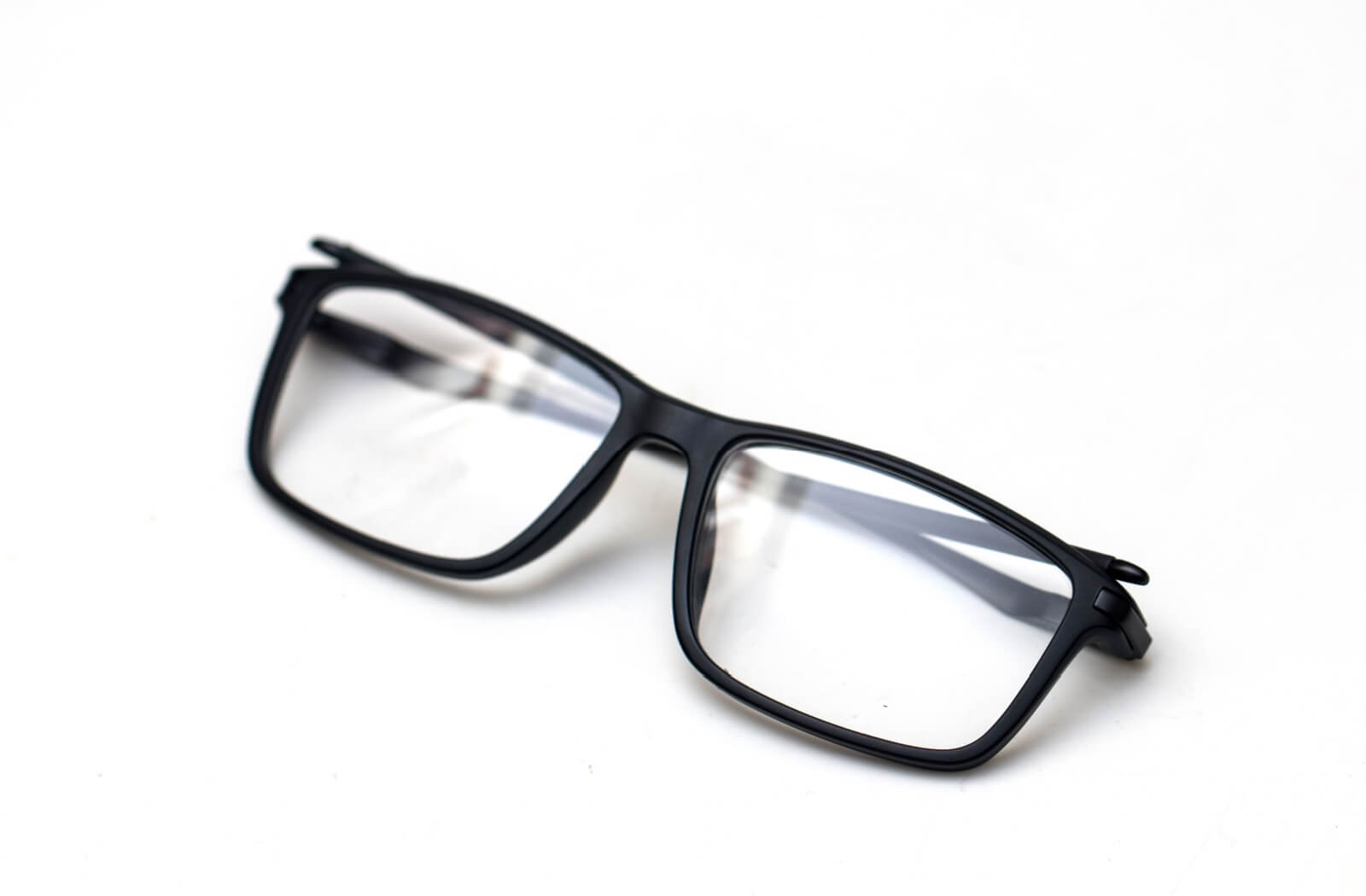 A pair of black-framed rectangular eyeglasses isolated on a clean white background.